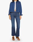 Woman wearing a blue denim jacket and jeans on a white background