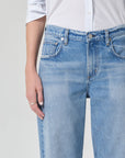 Light blue jeans worn by a person on a plain background