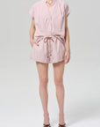 Person wearing a pink striped set on a white background