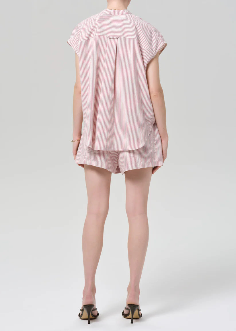 Person wearing a pink striped outfit on a white background