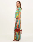 Woman wearing a colorful striped outfit with a white background