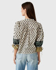 model wearing print rory top with jeans on a white background, back