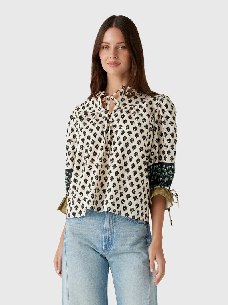 model wearing print rory top with jeans on a white background