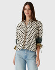 model wearing print rory top with jeans on a white background