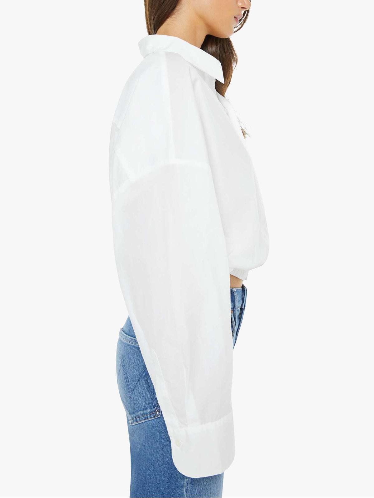 Woman wearing a white shirt with a high collar on a white background