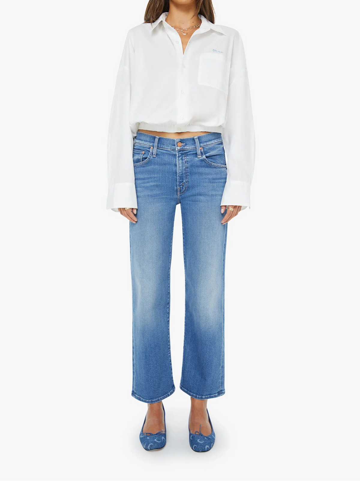 Woman wearing a white blouse and blue jeans on a white background