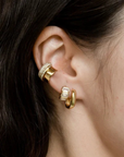 Sunset Huggie Hoop Earrings with other earrings on model