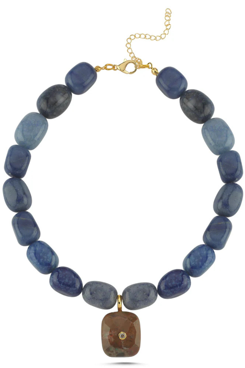 Necklace with blue beads and a gold clasp on a white background