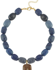 Necklace with blue beads and a gold clasp on a white background