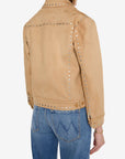 A person shown from the back wearing a tan suede jacket with silver stud detailing and blue jeans, photographed against a plain light gray studio background.