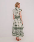 Woman wearing a green and white patterned matching set on a plain background