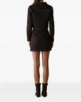 A model shown from the back wearing a chocolate jacket with matching mini skirt with gold zipper on a white background