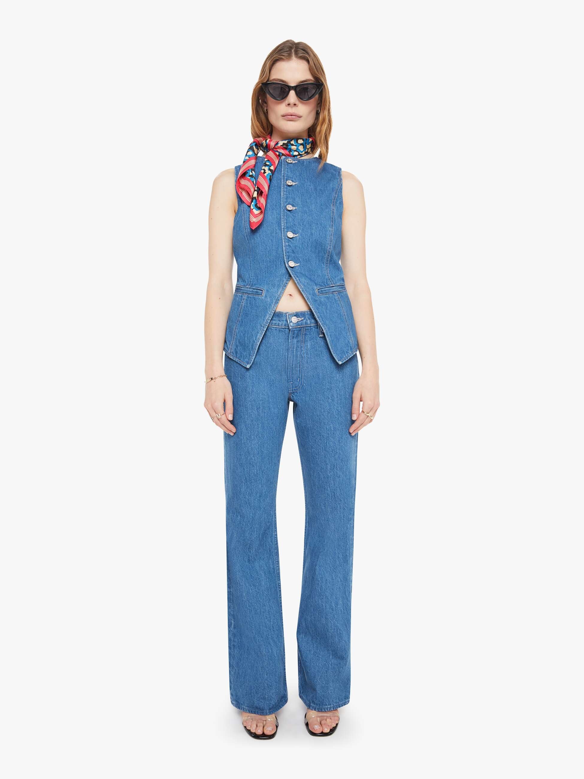 Woman wearing a blue denim outfit with a scarf on a white background, full body front