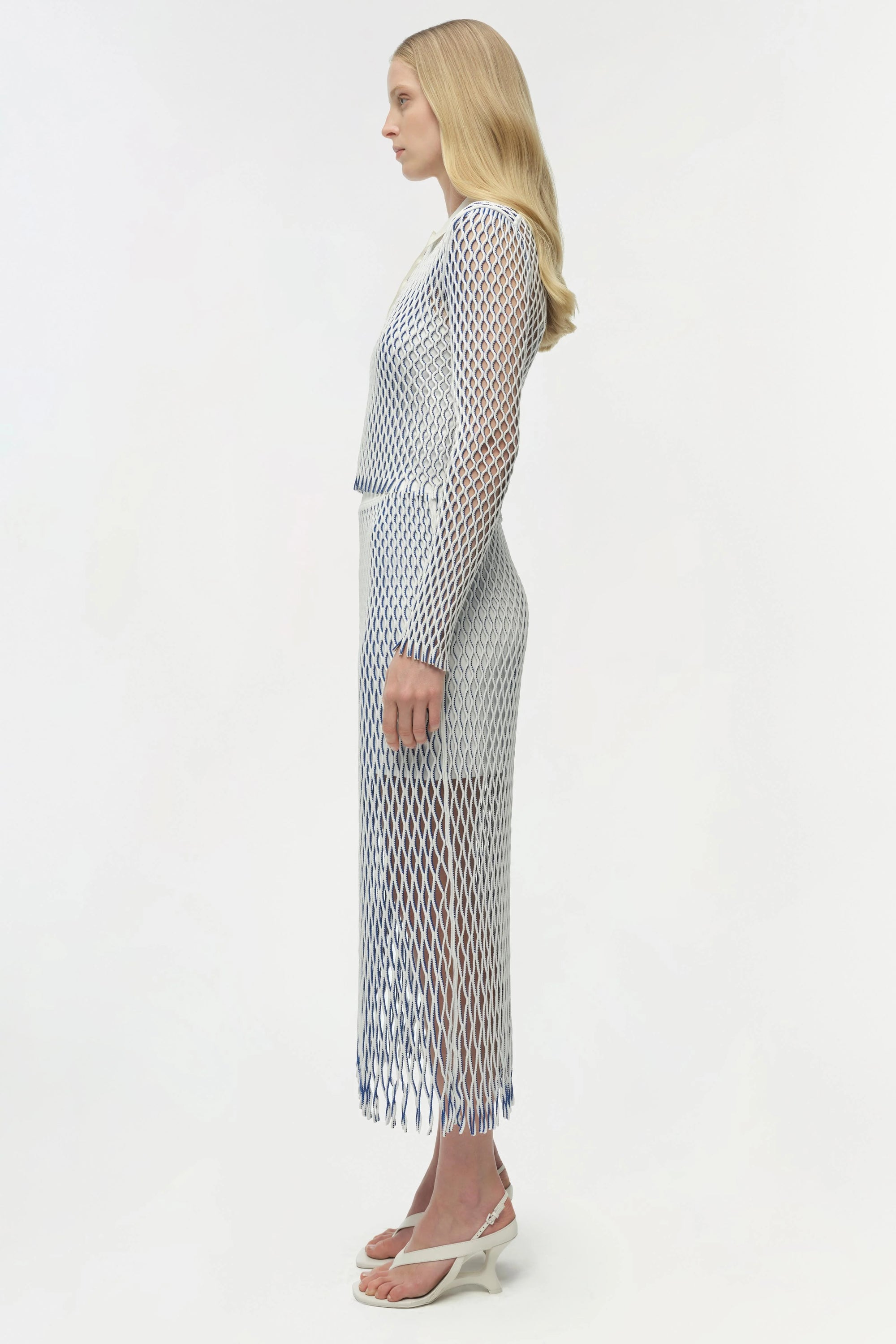 Woman wearing a patterned dress on a white background