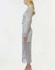 Woman wearing a patterned dress on a white background