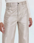 Beige pants worn by a person on a light blue background