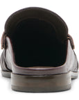 A close-up rear view of a dark brown leather loafer with a textured finish and a dark sole, shown against a plain white background.