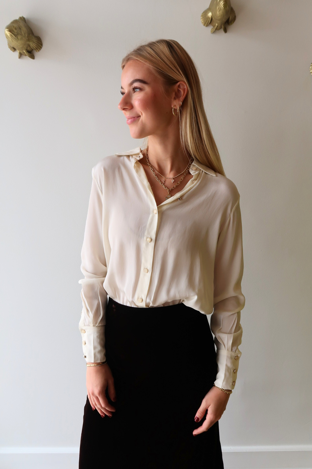 Woman wearing Alyssa Long Sleeve Bodysuit in Ivory and Felicity Velvet Midi Skirt against a plain background, front