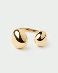Gold ring with a minimalist design on a light gray background