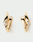 Gold earrings with diamond accents on a light gray background