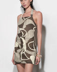 Woman wearing a patterned dress on a white background