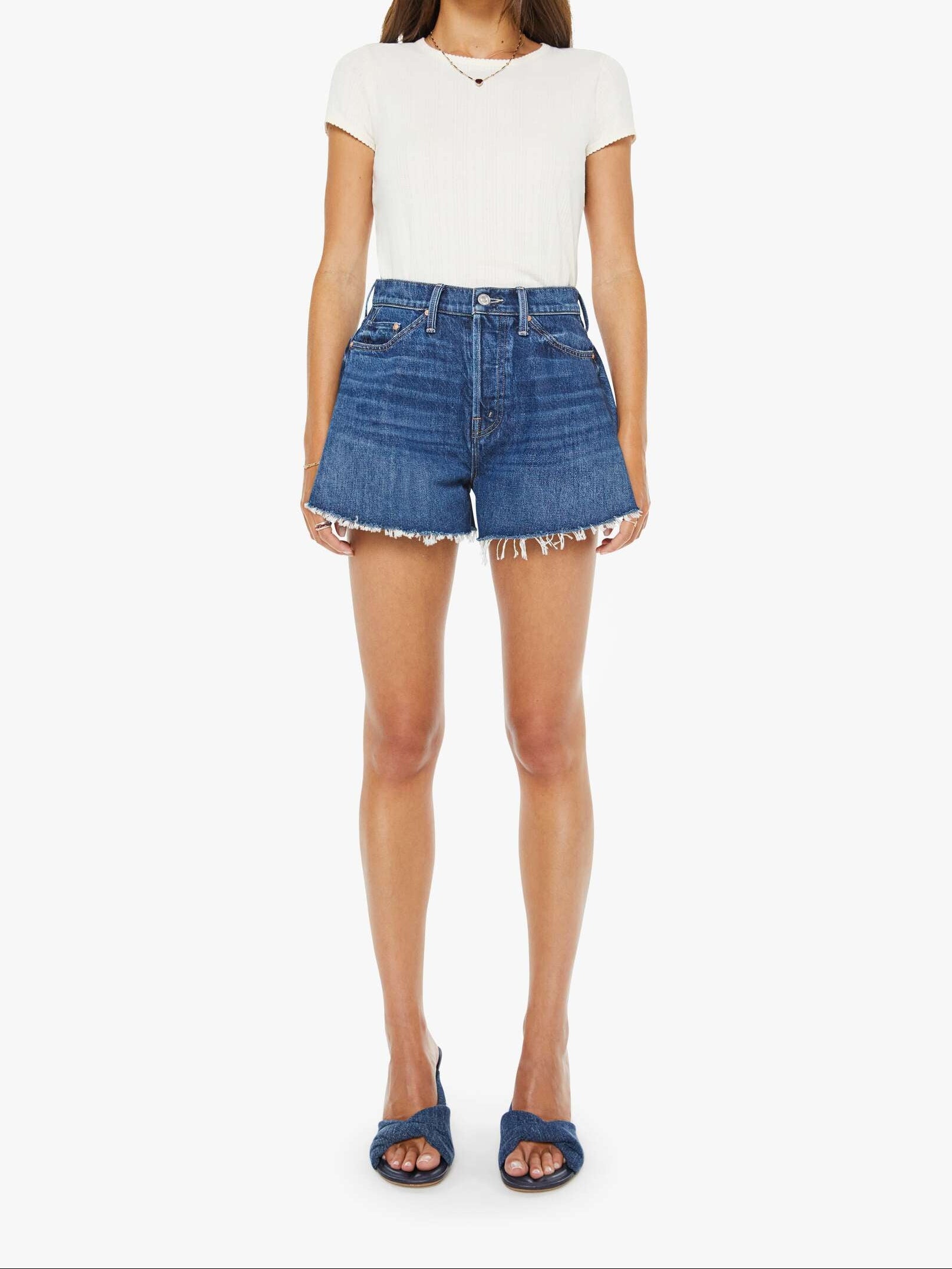 Woman wearing a white t-shirt and blue denim shorts on a white background