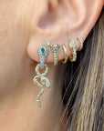 Single Diamondback Emerald Snake Hoop, first hole. Single King Cobra Hoop Earring with other earrings on ear, second hole