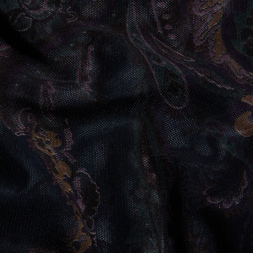 A close-up of a dark woven fabric with a subtle paisley pattern in black, deep purple, and muted gold.