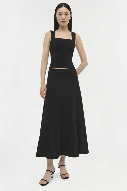 Woman wearing a black dress on a white background