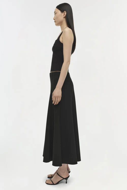 Woman wearing a black dress on a white background