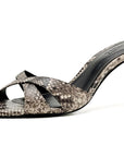 A single women's high-heeled sandal with a snakeskin pattern in shades of gray, beige, and black, featuring crisscrossing straps and a pointed toe, shown against a plain white background.