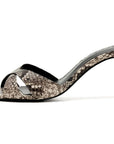 A single women's heeled sandal with a snakeskin pattern in beige, brown, and black, featuring a pointed toe, open side, and a slim high heel on a white background.