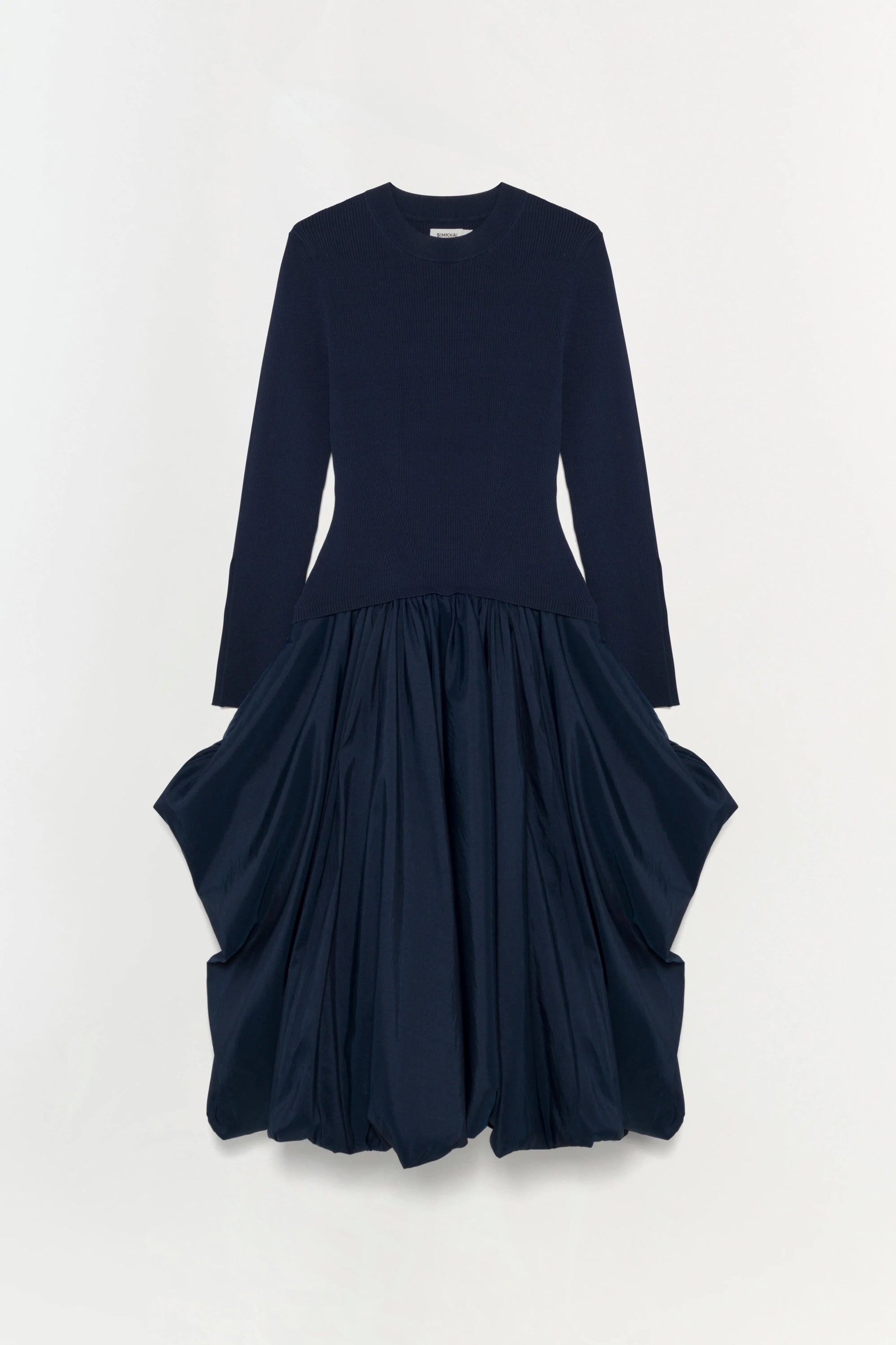 Navy blue dress with long sleeves and layered skirt on a white background