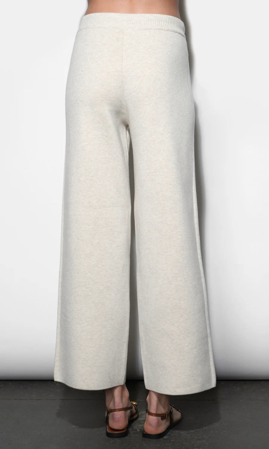 White wide-leg pants worn by a person on a plain background