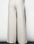 White wide-leg pants worn by a person on a plain background