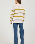 Person wearing a striped sweater and jeans on a white background