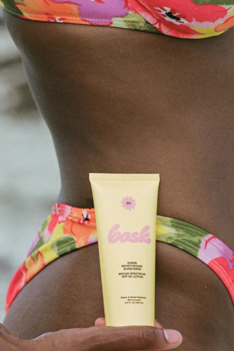 SPF 50 Lotion Sunscreen Travel Size next to model
