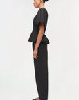 Woman wearing a black outfit on a white background