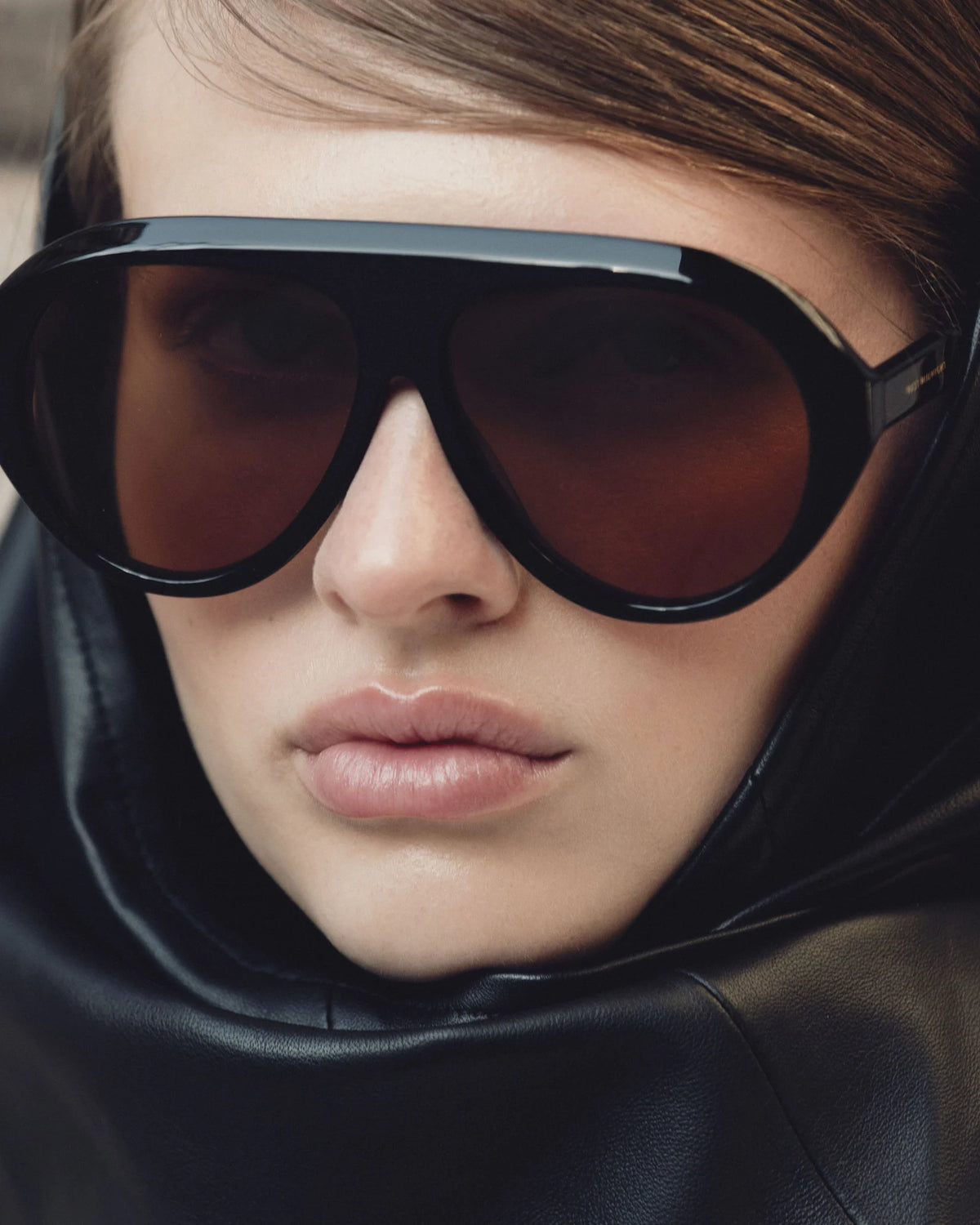 model wearing Sunglasses with brown lenses and black frame 