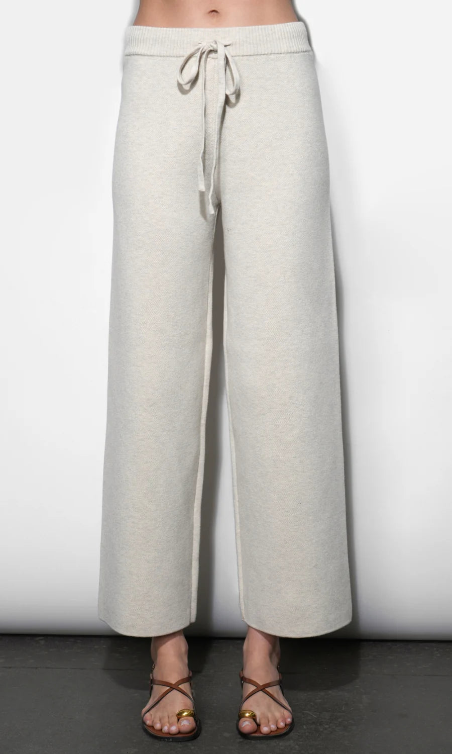 Light gray wide-leg pants with a drawstring waist on a white background