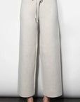 Light gray wide-leg pants with a drawstring waist on a white background