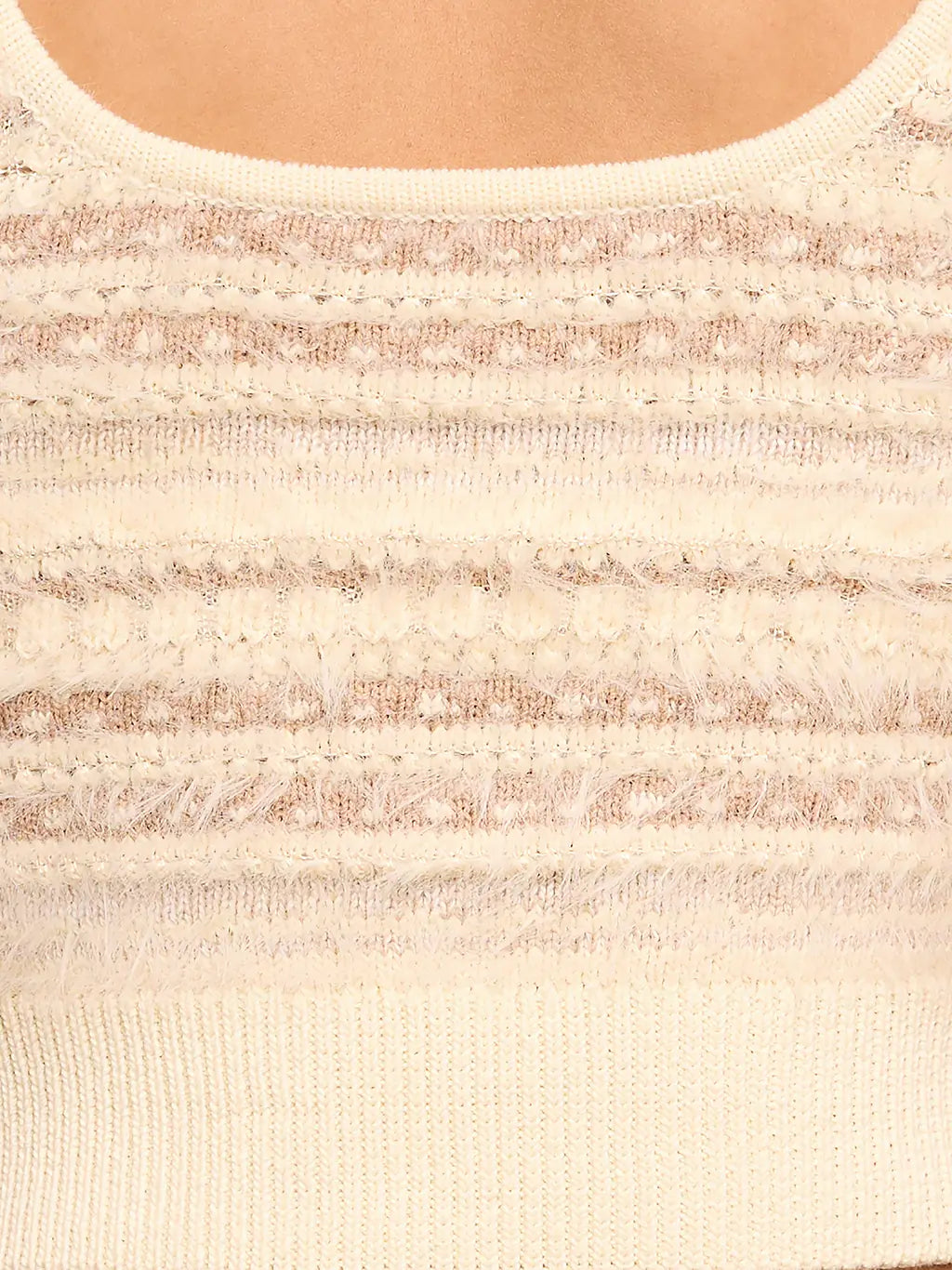 Close-up of a cream-colored knit sweater with textured horizontal stripes and a ribbed crew neck.