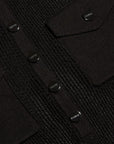 Close-up of a black textured knit cardigan featuring a buttoned chest pocket and matching buttoned flap pockets, with the brand name 'LAGENCE visible on the buttons.