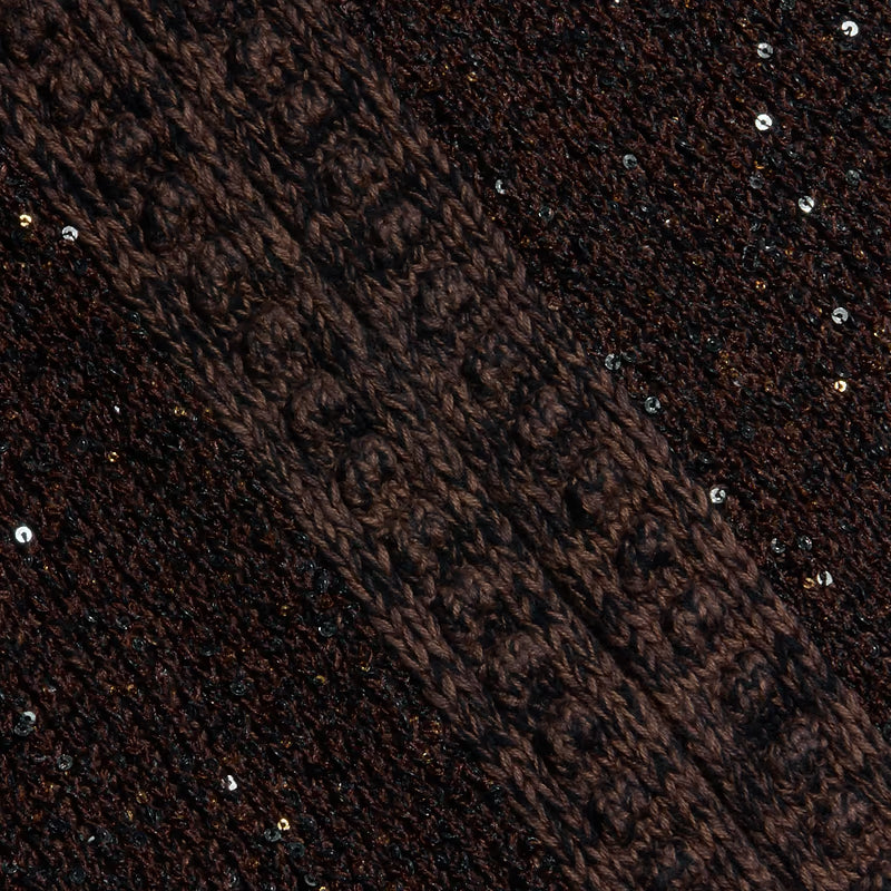 Close-up of a dark brown knit fabric with textured stripes and scattered small reflective sequins.