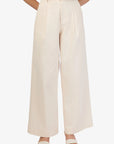 Beige wide-leg pants worn by a person on a white background front view