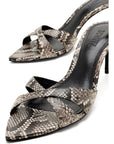 A pair of pointed-toe heeled mule sandals featuring a snakeskin pattern in beige, brown, and gray, with black trim and a black insole displaying the brand name 'ZAHROS'.