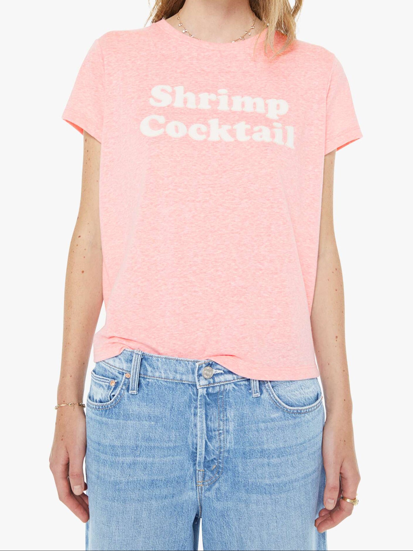 Person wearing a pink t-shirt with text and blue jeans on a white background