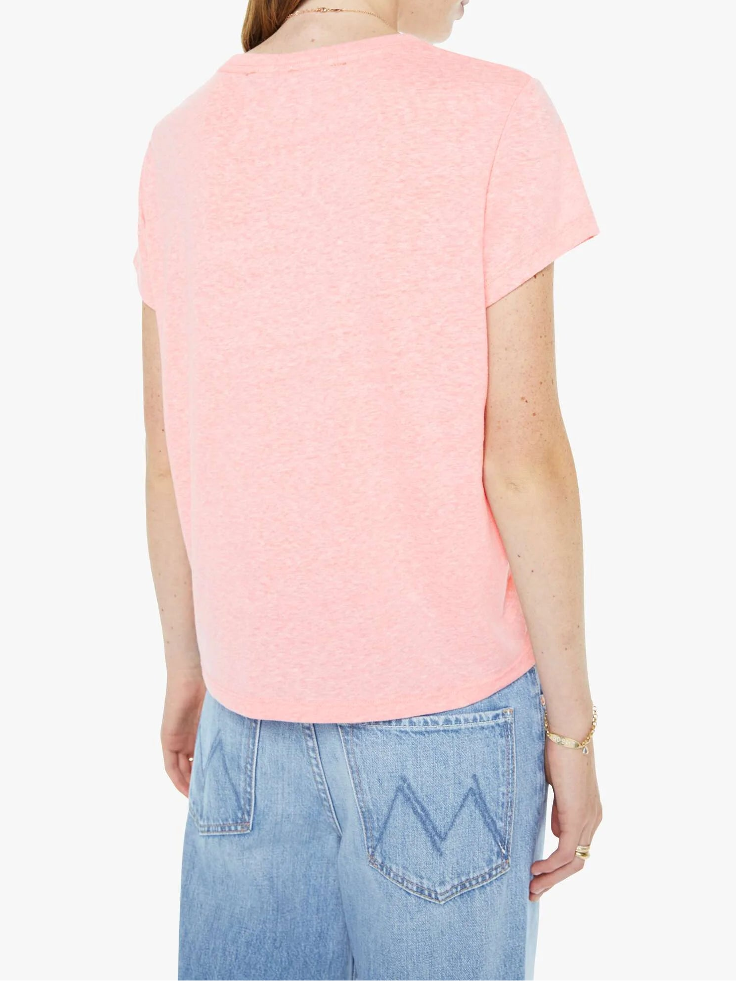 Woman wearing a pink t-shirt and blue jeans on a white background
