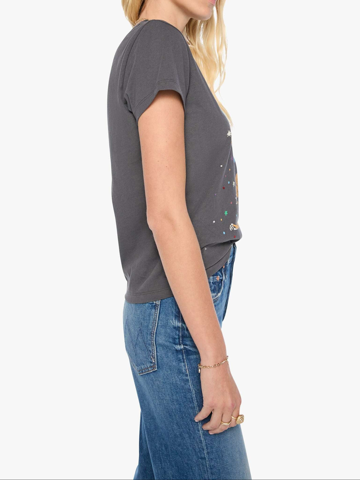 Woman wearing a gray t-shirt and blue jeans on a white background