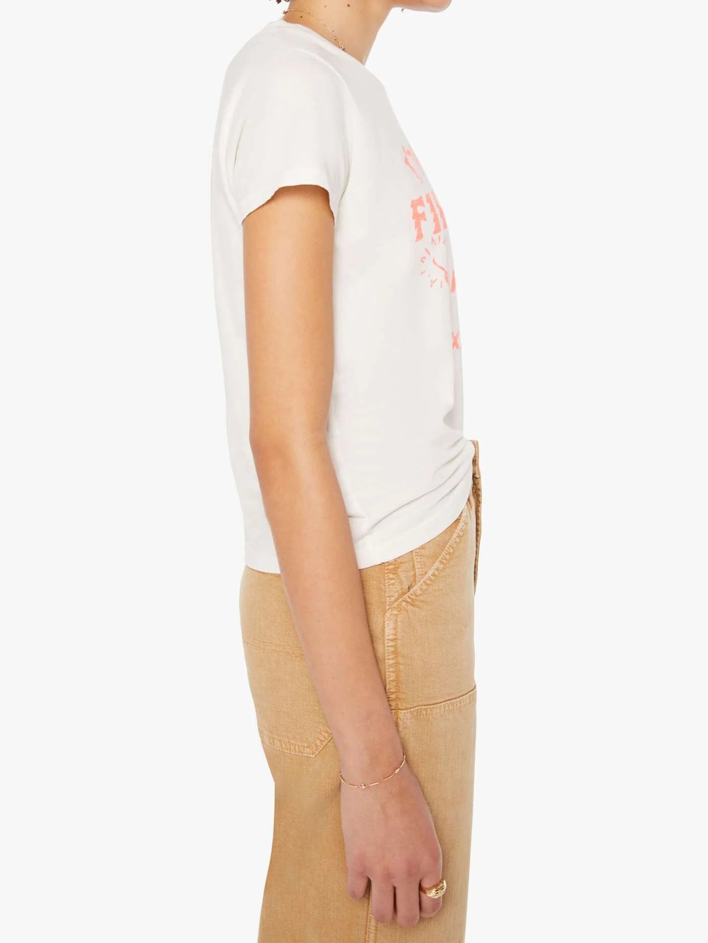 Person wearing a white t-shirt with a graphic design on a plain background, side view